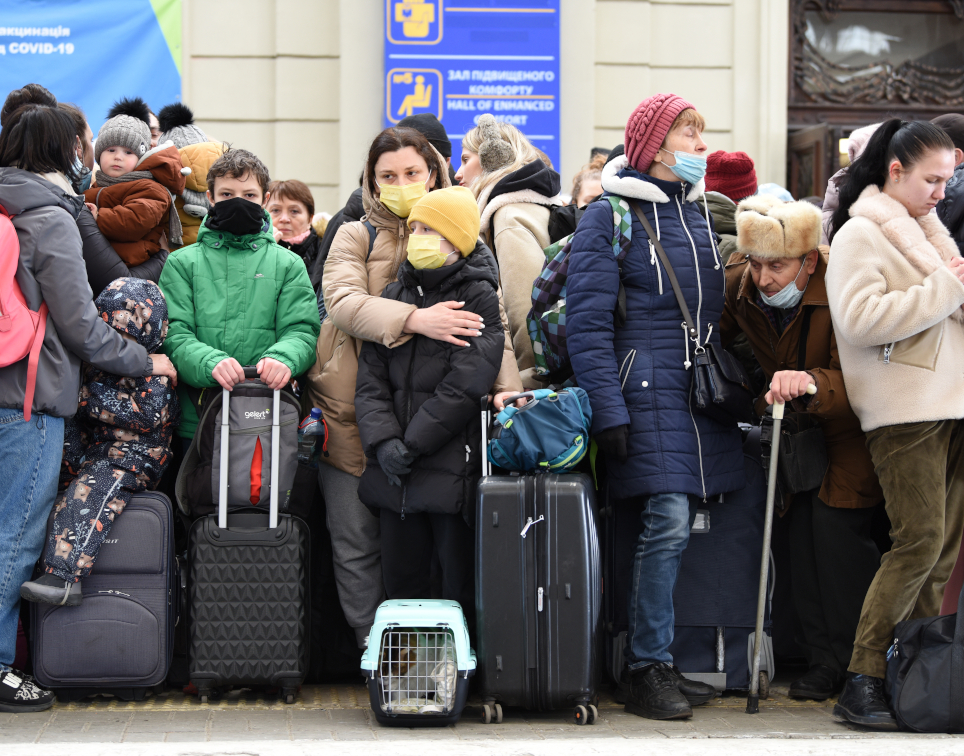 Geflüchtete aus der Ukraine stehen an einem Bahngleis